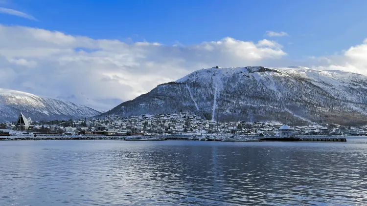 Snowy hill and Tromsø city skyl