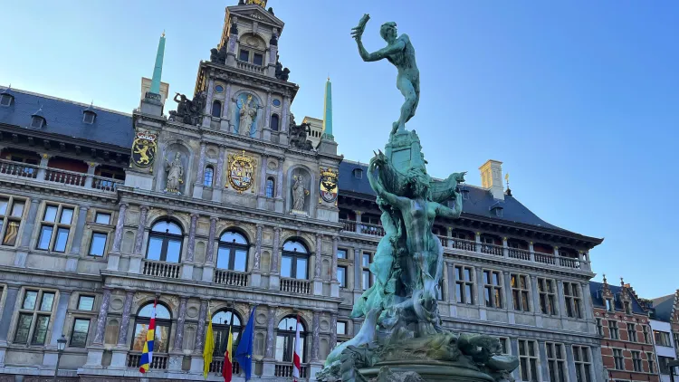 Copper statue of Antwerp legend in front of town hall