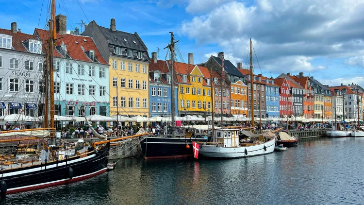 Waterway with colorful buildings lining it (blue, yellow, red)